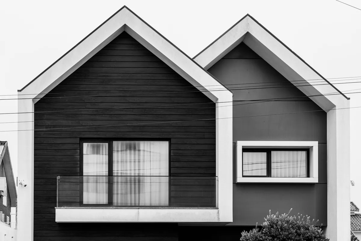 Striking minimalist facade of a modern house with geometric patterns in black and white.